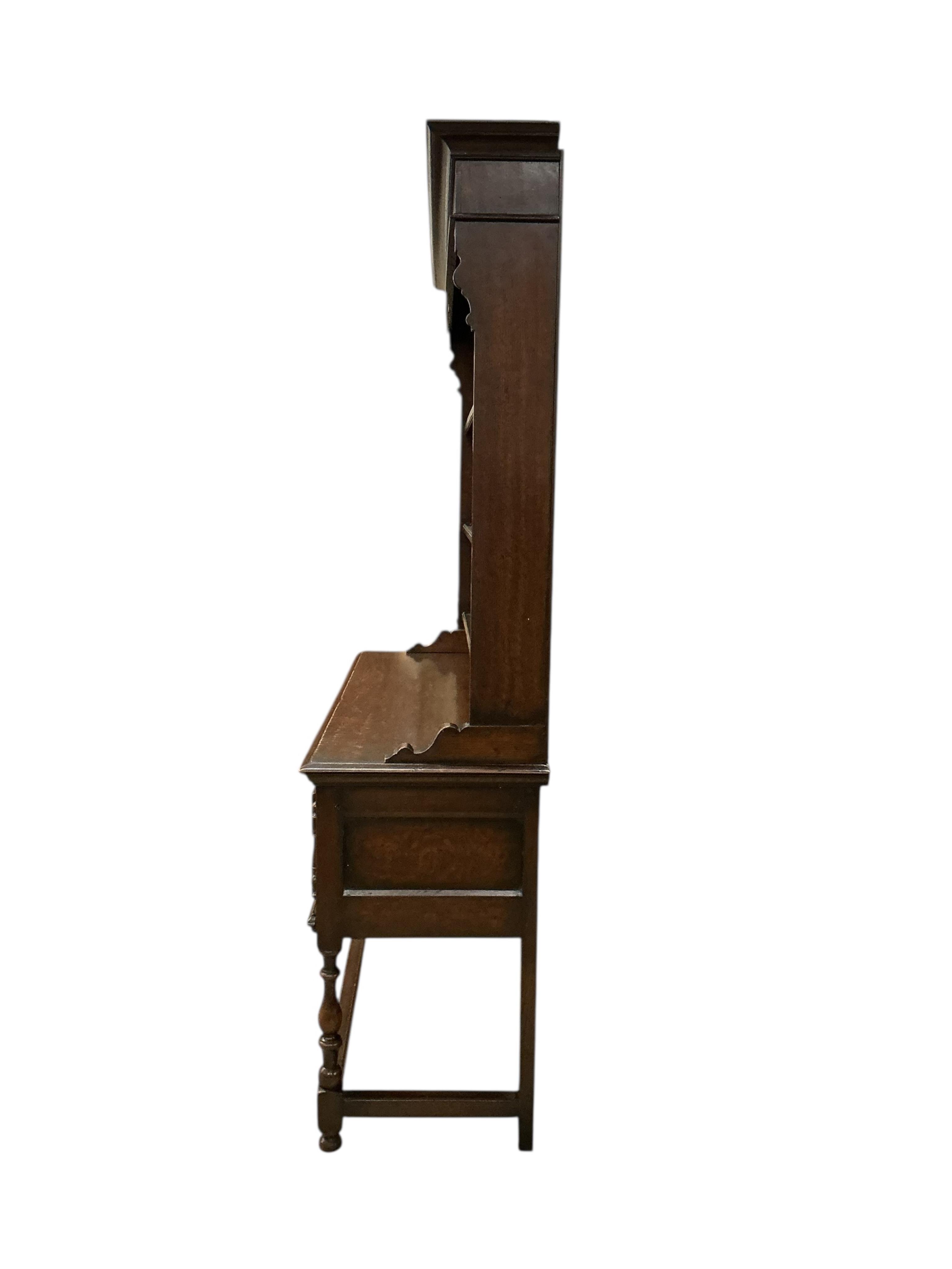 An early 20th century Jacobean Revival oak dresser with boarded rack, width 152cm, depth 51cm, height 206cm